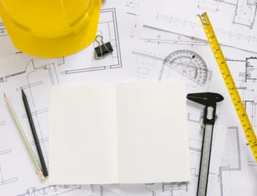helmet-and-drafting-supplies-on-blueprints-1 helmet-and-drafting-supplies-on-blueprints-1